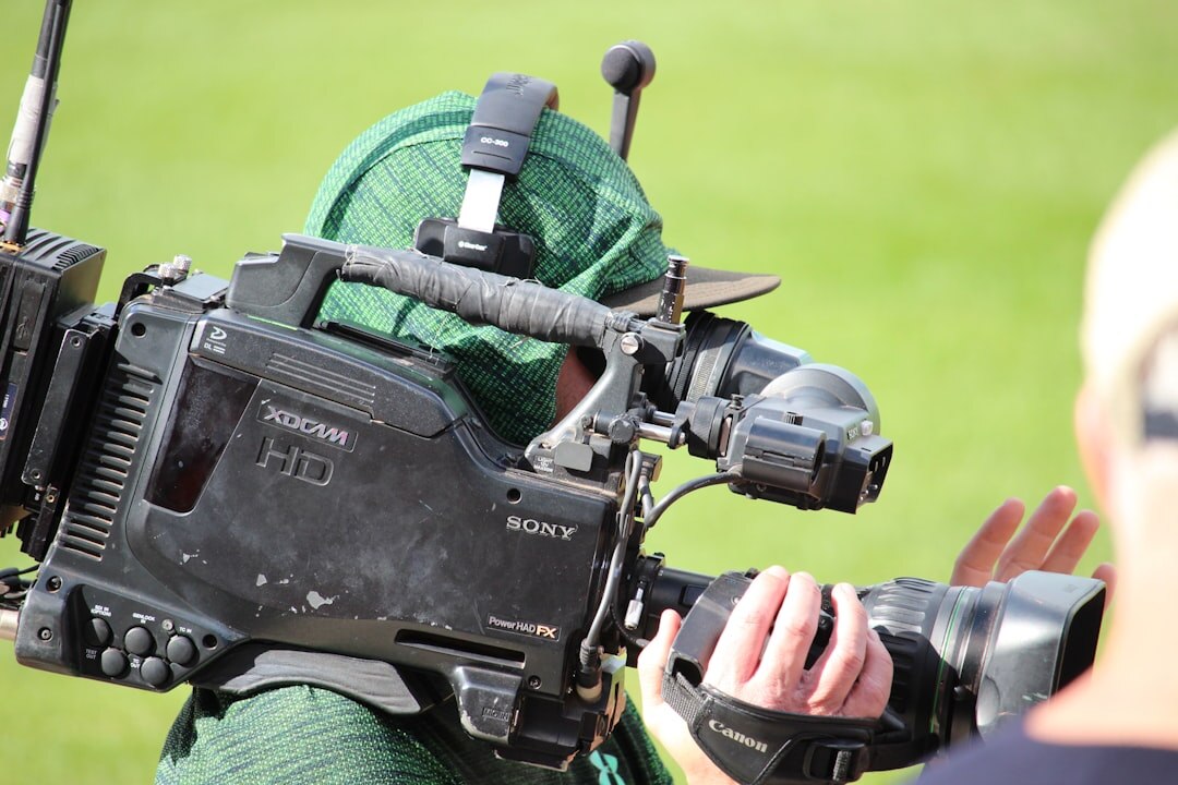 Television camera operator filming from a marked press position