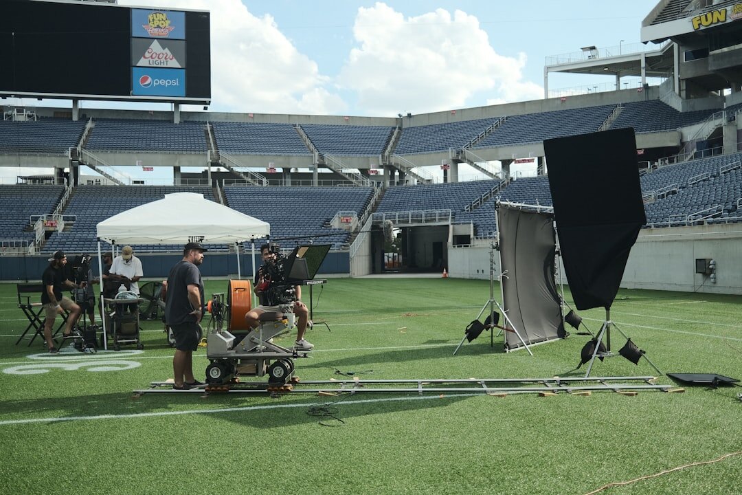 Camera crew setting up a satellite truck for a live broadcast point